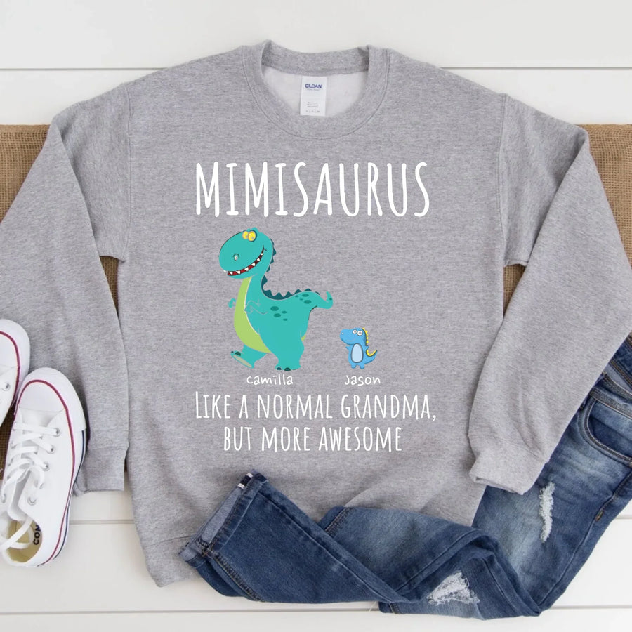 Black t-shirt with a colorful dinosaur design and text 'MIMISARUS like a normal grandma, but more awesome' along with three names: Camilla, Jason, and Mike. 