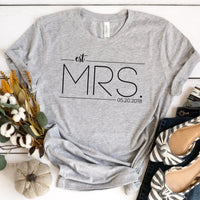 A white crew neck t-shirt with the text 'est. MRS.
