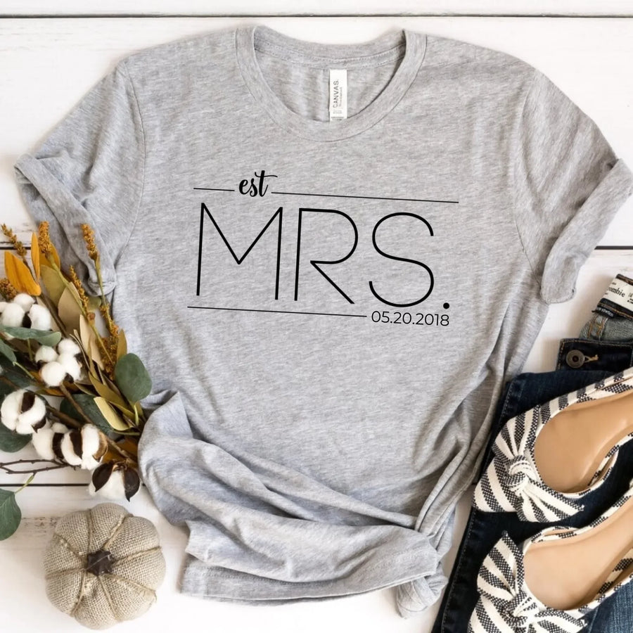 A white crew neck t-shirt with the text 'est. MRS.