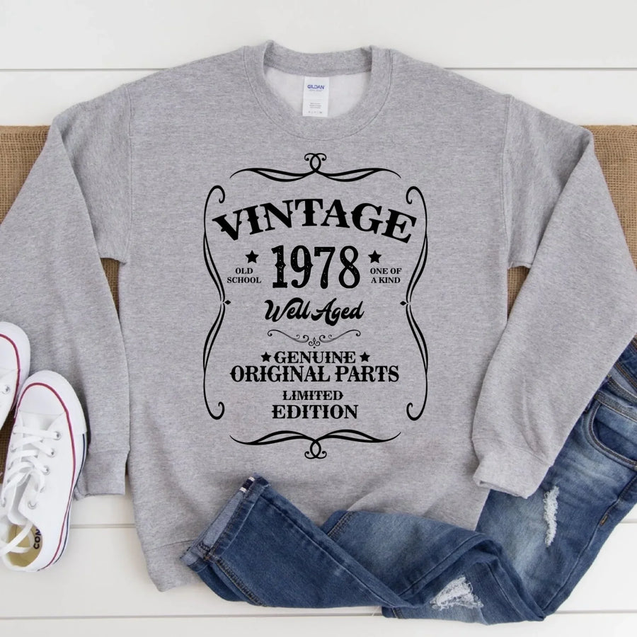 May include a personalized vintage-style birthday T-shirt with the words Well Aged and a custom year printed on the front.