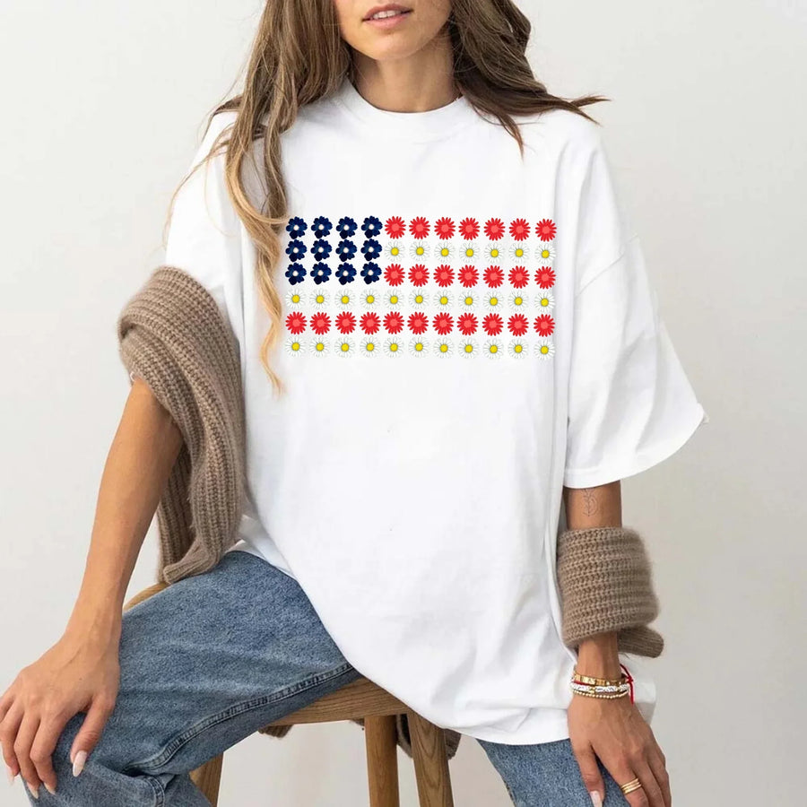 Woman wearing white oversized t-shirt with American flag floral print, casual style