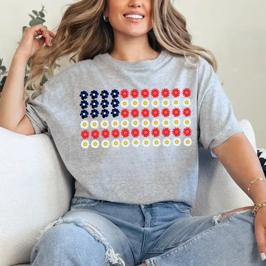Woman wearing a gray t-shirt with a floral American flag graphic, casual jeans outfit