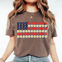 Woman wearing brown tee with American flag made of blue, red, and white daisy flowers