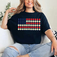 Woman wearing a black t-shirt with a floral American flag graphic, sitting casually.