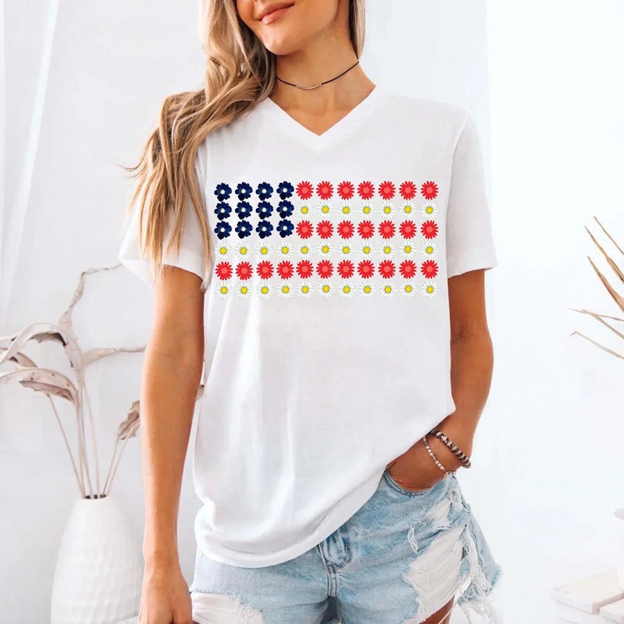 Woman wearing white v-neck tee with American flag made of colorful flowers, casual summer style.