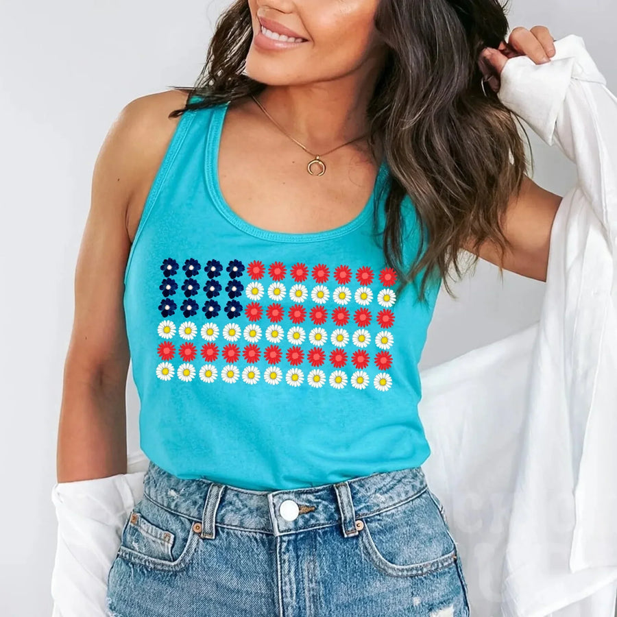 Woman in blue tank top with floral American flag print and denim shorts