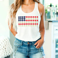 Woman wearing white tank top with floral American flag design and denim shorts