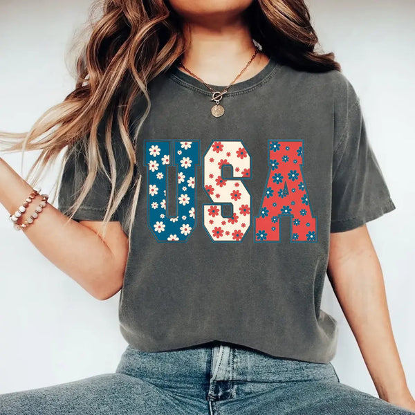 Person wearing a gray t-shirt with 'USA' design on a white background