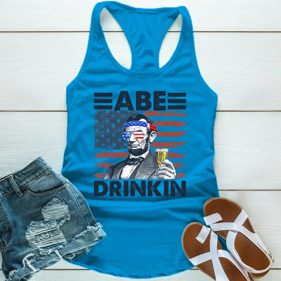 Blue tank top with cartoon Abraham Lincoln holding beer, USA flag graphics, summer casual outfit