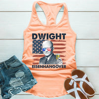 Peach tank top with graphic design and text, paired with denim shorts and sandals on a wooden surface.