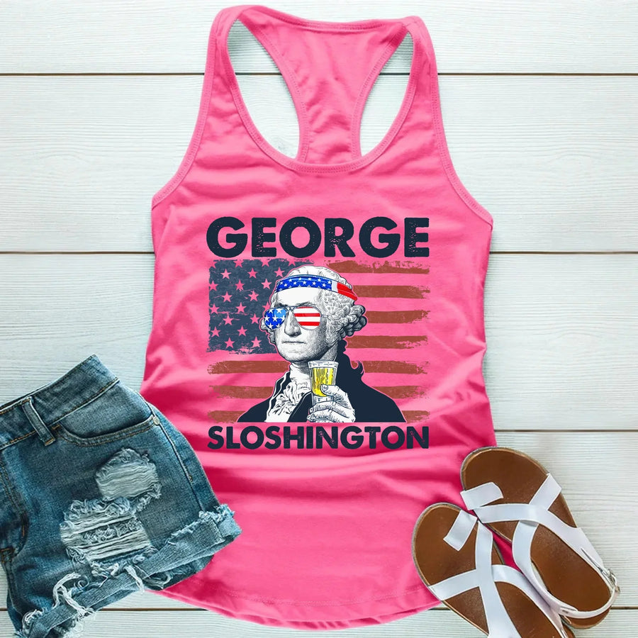 Pink tank top with 'George Sloshington' graphic on a wooden surface with shorts and sandals.