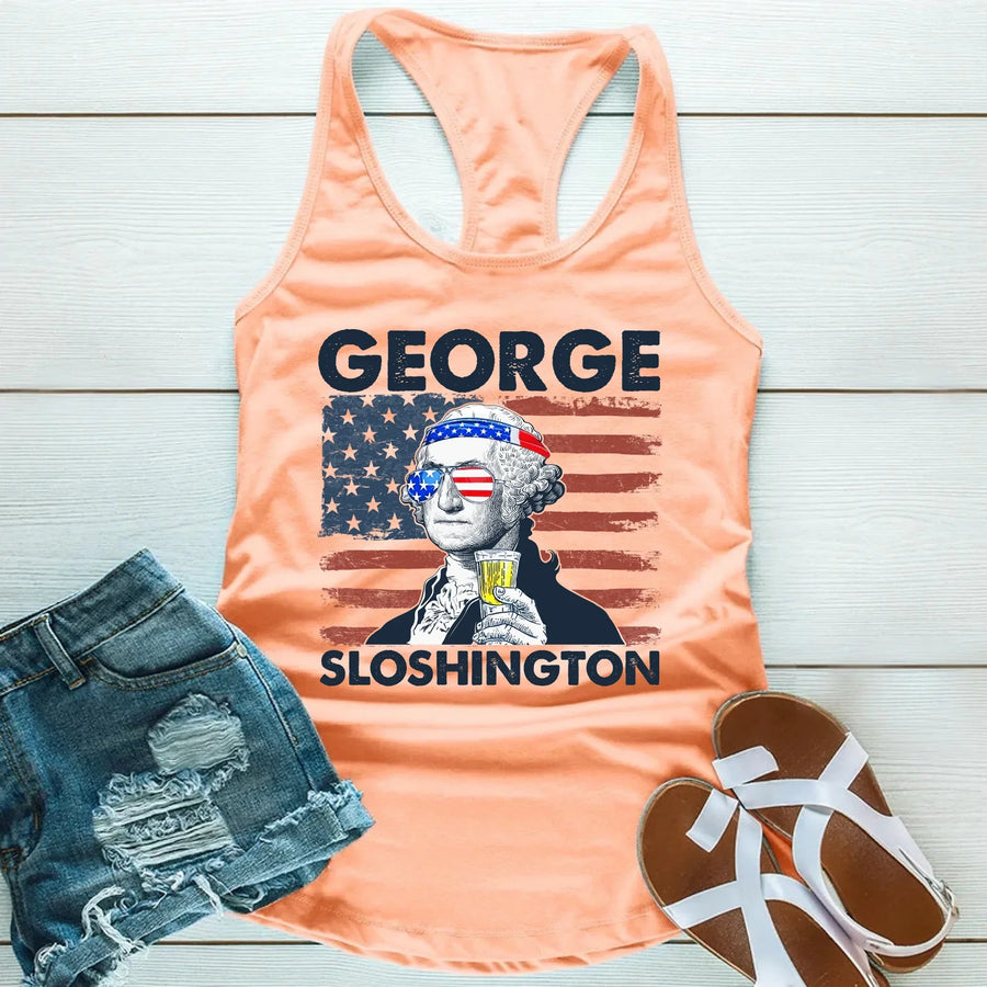 Peach tank top with 'George Sloshington' graphic, denim shorts, and sandals on a light wooden surface.
