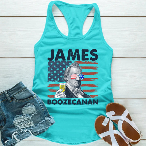 Turquoise tank top with 'JAMES BOOZECANAN' graphic on a wooden surface with denim shorts and sandals.