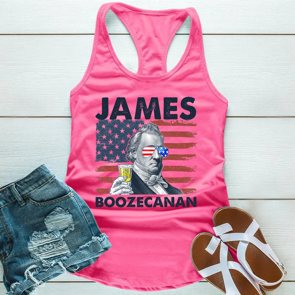 Pink tank top with 'James Boozecanan' graphic on a wooden surface with denim shorts and sandals.