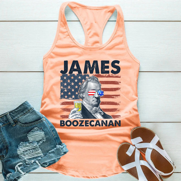 Peach tank top with 'James Boozecanan' graphic, denim shorts, and sandals on a wooden surface