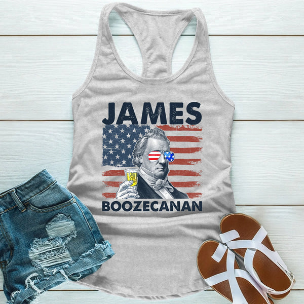 Gray tank top with American flag design and text, paired with denim shorts and sandals on a wooden surface.