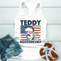 Tank top with a graphic of a historical figure and text, paired with denim shorts and sandals on a wooden surface.