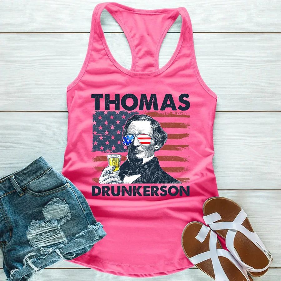 Pink tank top with graphic design and denim shorts on a wooden surface