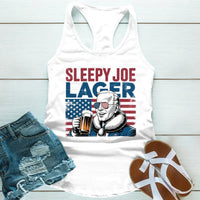 White tank top with 'Sleepy Joe Lager' graphic, denim shorts, and sandals on a light wooden surface.