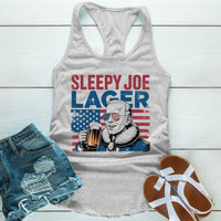 Gray tank top with 'Sleepy Joe Lager' graphic, denim shorts, and sandals on a wooden surface