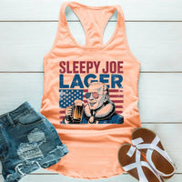 Peach tank top with 'Sleepy Joe Lager' graphic, denim shorts, and sandals on a wooden surface