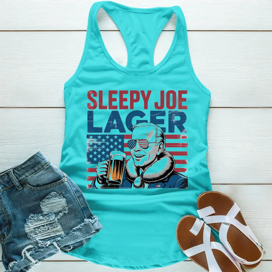 Turquoise tank top with 'Sleepy Joe Lager' graphic on a wooden surface with denim shorts and sandals.