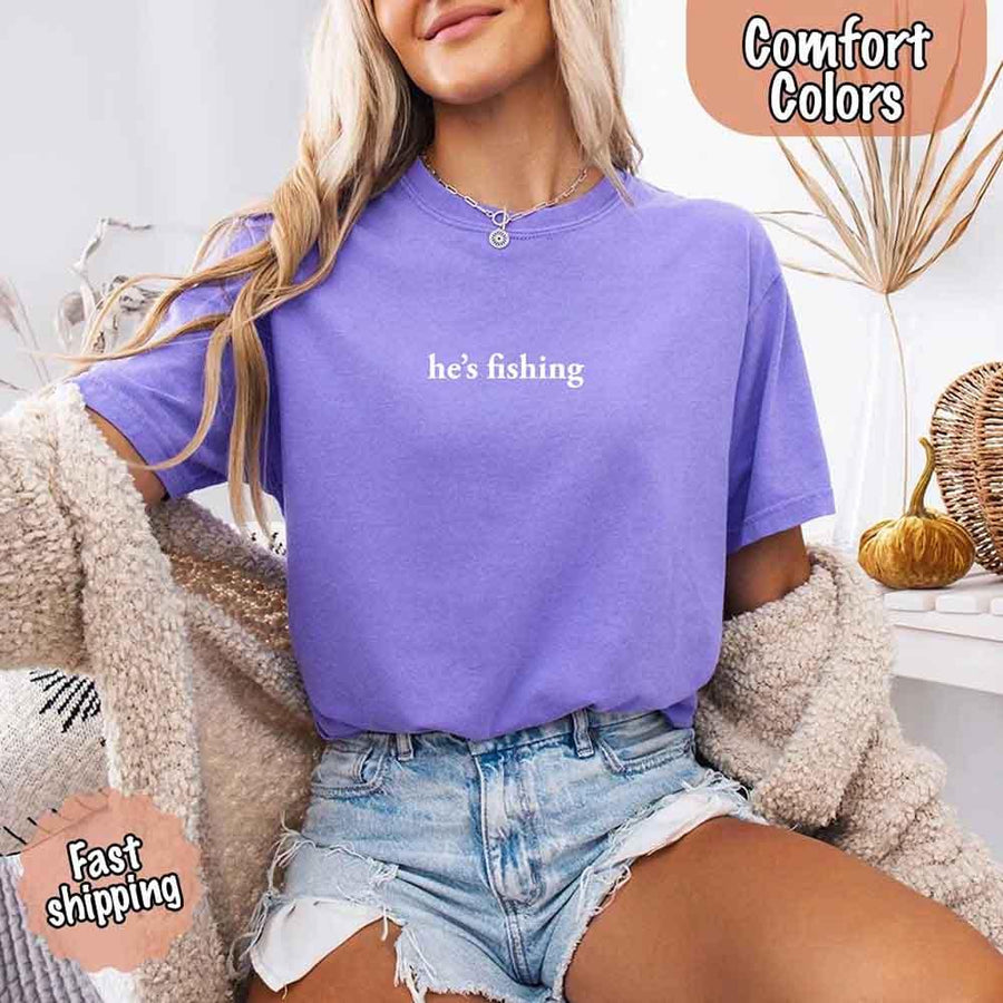 May include a Comfort Colors t-shirt with the phrase 'He’s Fishing' — a funny and laid-back design, ideal for women who enjoy a relaxed fit with humor