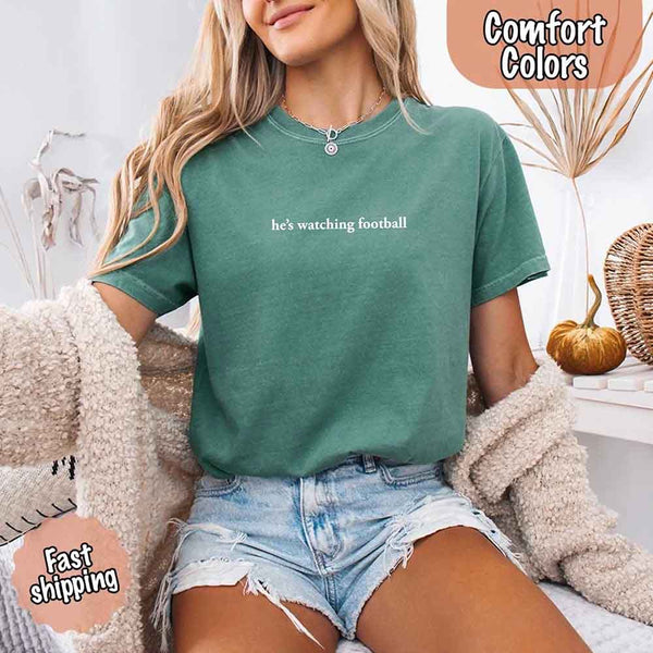 He’s Watching Football Tee - Comfort Colors Funny Shirt for Her