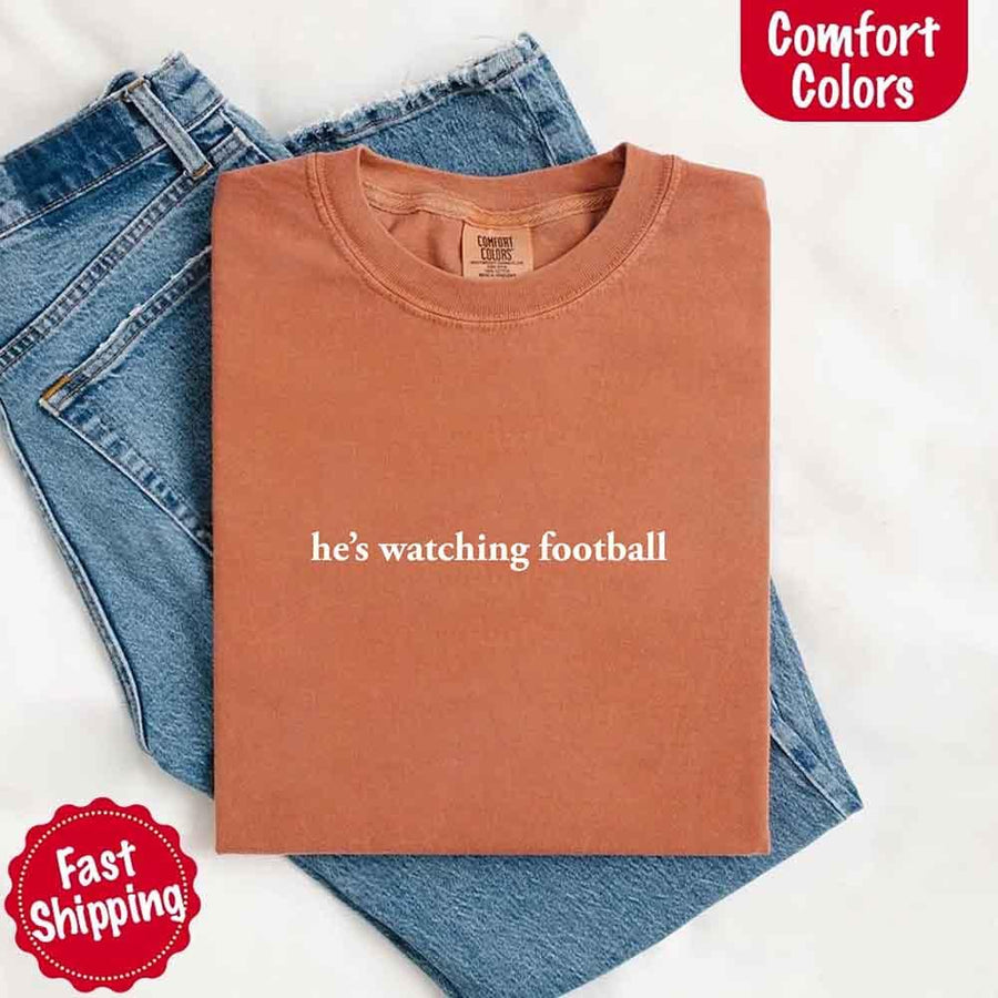 He’s Watching Football Tee - Comfort Colors Funny Shirt for Her
