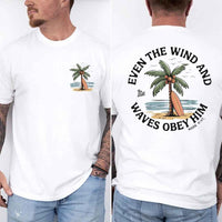 May include a man wearing a white t-shirt featuring a small front graphic of a palm tree and surfboard, with a larger back design showing the same illustration surrounded by the Bible verse 'Even the Wind and Waves Obey Him – Mark 4:41