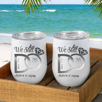 Two white tumblers with 'We Still Do' engraving in a wooden tray with a beach background.