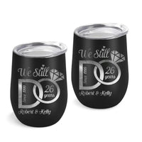 Two black tumblers with silver text and designs on a white background