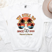 White sweatshirt with 'We Still Do Since 1999' design featuring sunglasses and palm trees on a white background.
