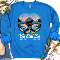 Blue custom sweatshirt with cruise ship, sunglasses, wedding rings, mountains, and 'We Still Do' text