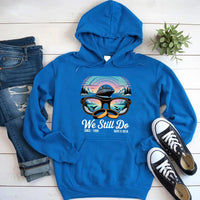Custom blue hoodie with cruise ship and sunglasses graphic, paired with jeans and sneakers