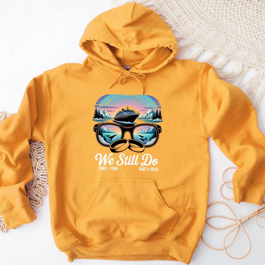 Yellow hoodie with cruise ship and sunglasses graphic, 'We Still Do' anniversary design