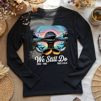 Black long sleeve tee with cruise ship, sunglasses, wedding rings, and 'We Still Do' graphic.