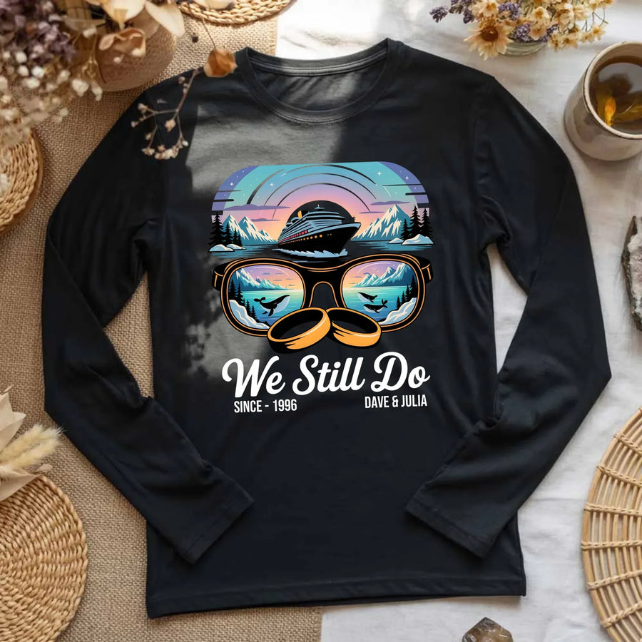 Black long sleeve tee with cruise ship, sunglasses, wedding rings, and 'We Still Do' graphic.