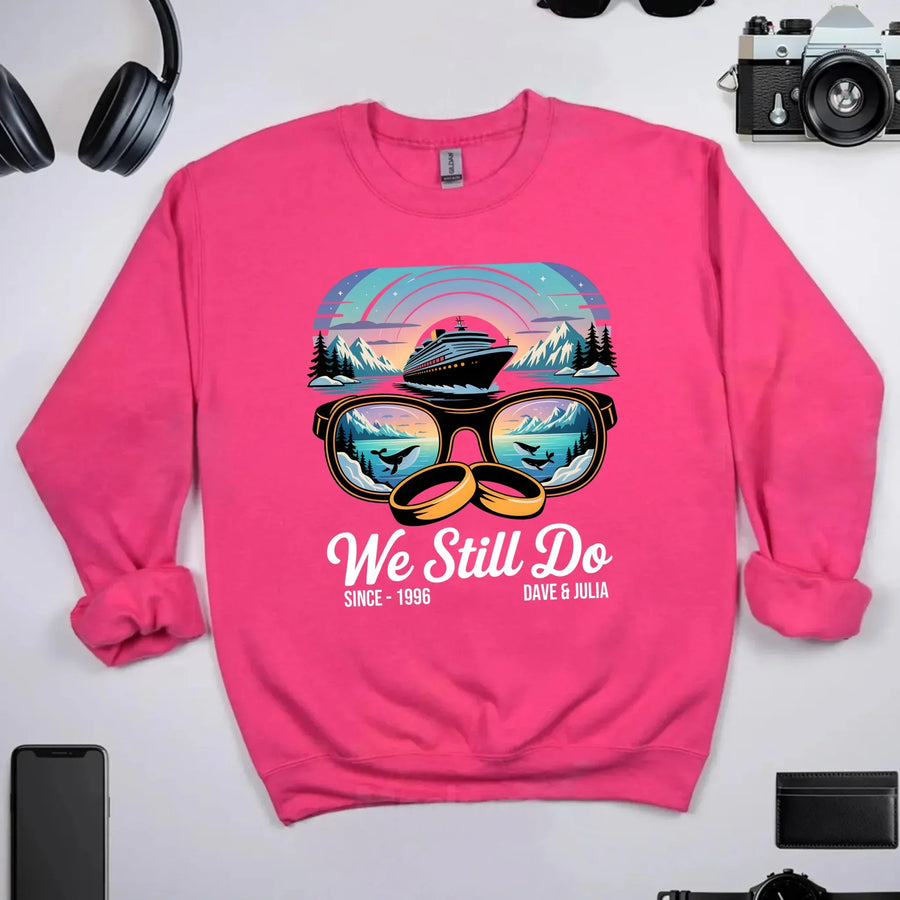Pink custom sweatshirt with cruise ship, sunglasses, mountain sunset, and 'We Still Do' text