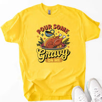 Yellow t-shirt with a graphic design and text 'Pour Some Gravy On Me' on a white background.