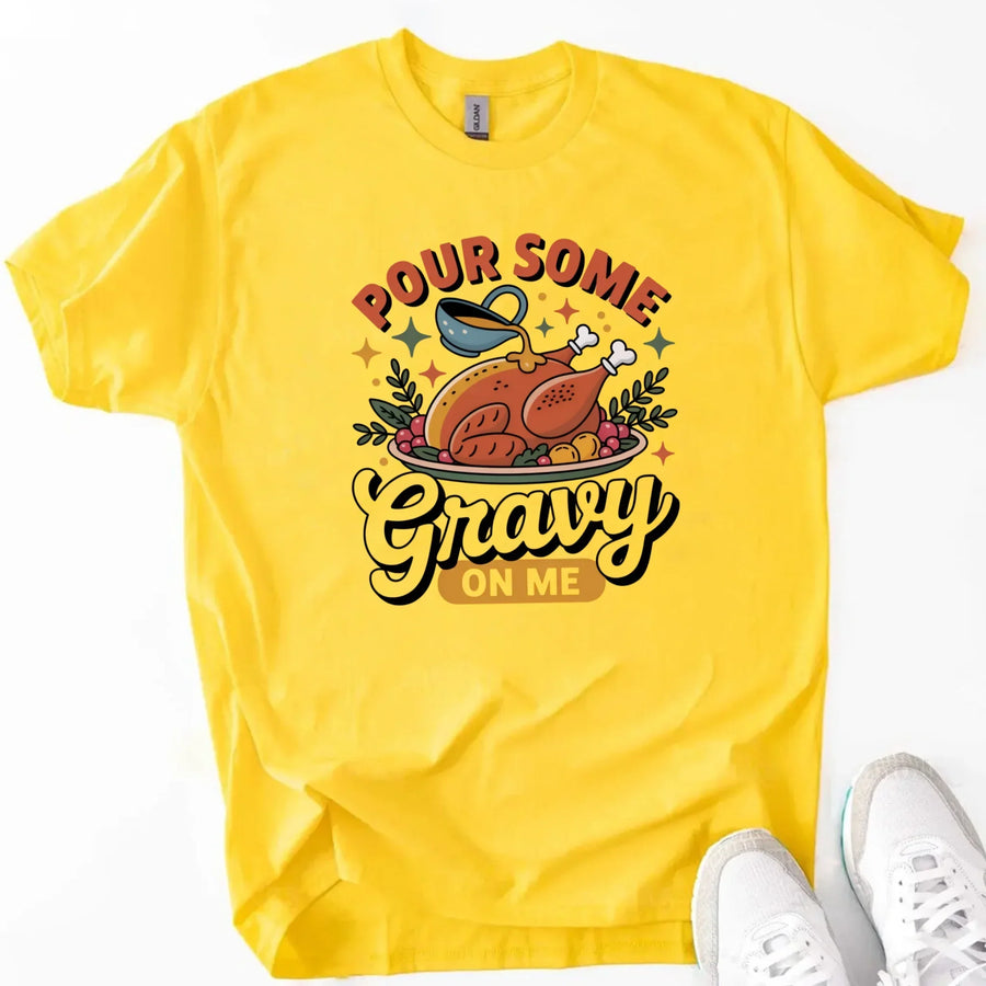 Yellow t-shirt with a graphic design and text 'Pour Some Gravy On Me' on a white background.