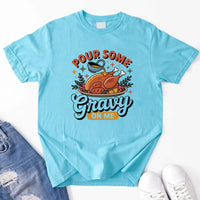 Light blue t-shirt with a graphic design and text 'Pour Some Gravy On Me' on a white background.