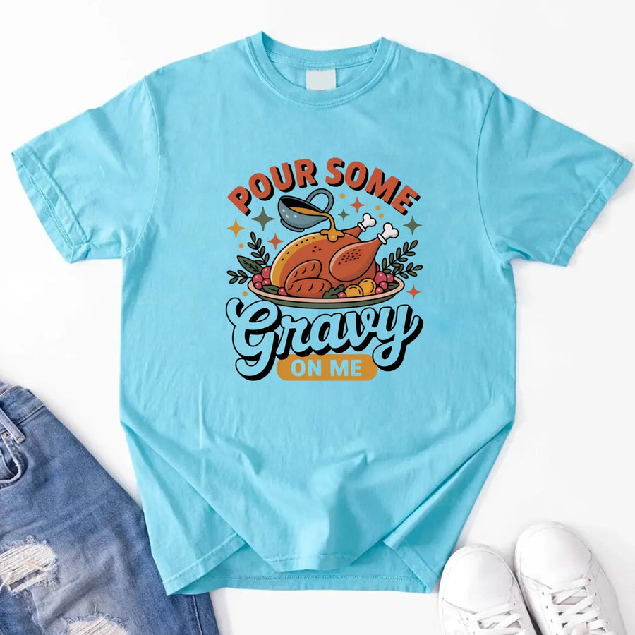 Light blue t-shirt with a graphic design and text 'Pour Some Gravy On Me' on a white background.