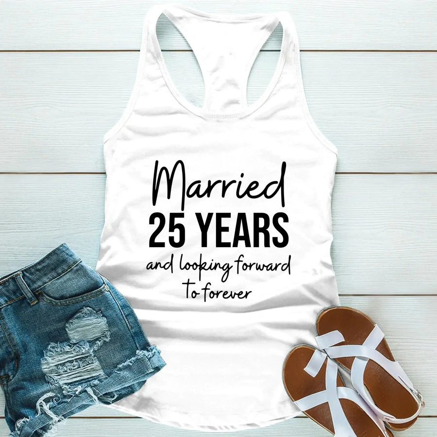 White tank top with 'Married 25 Years and looking forward to forever' text, paired with denim shorts and sandals on a light wooden surface.