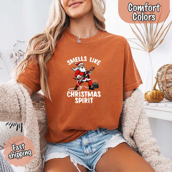May include a Comfort Colors unisex t-shirt featuring a vintage-style Santa Claus graphic and the text “Smells Like Christmas Spirit” printed on soft cotton fabric.