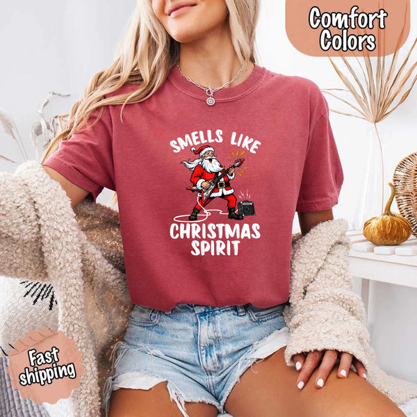 May include a Comfort Colors unisex t-shirt featuring a vintage-style Santa Claus graphic and the text “Smells Like Christmas Spirit” printed on soft cotton fabric.