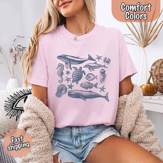 May include vintage-style blue illustrations of sea creatures such as whales, sea turtles, jellyfish, seahorse, starfish, fish, crab, and nautilus, evoking ocean life and coastal charm.