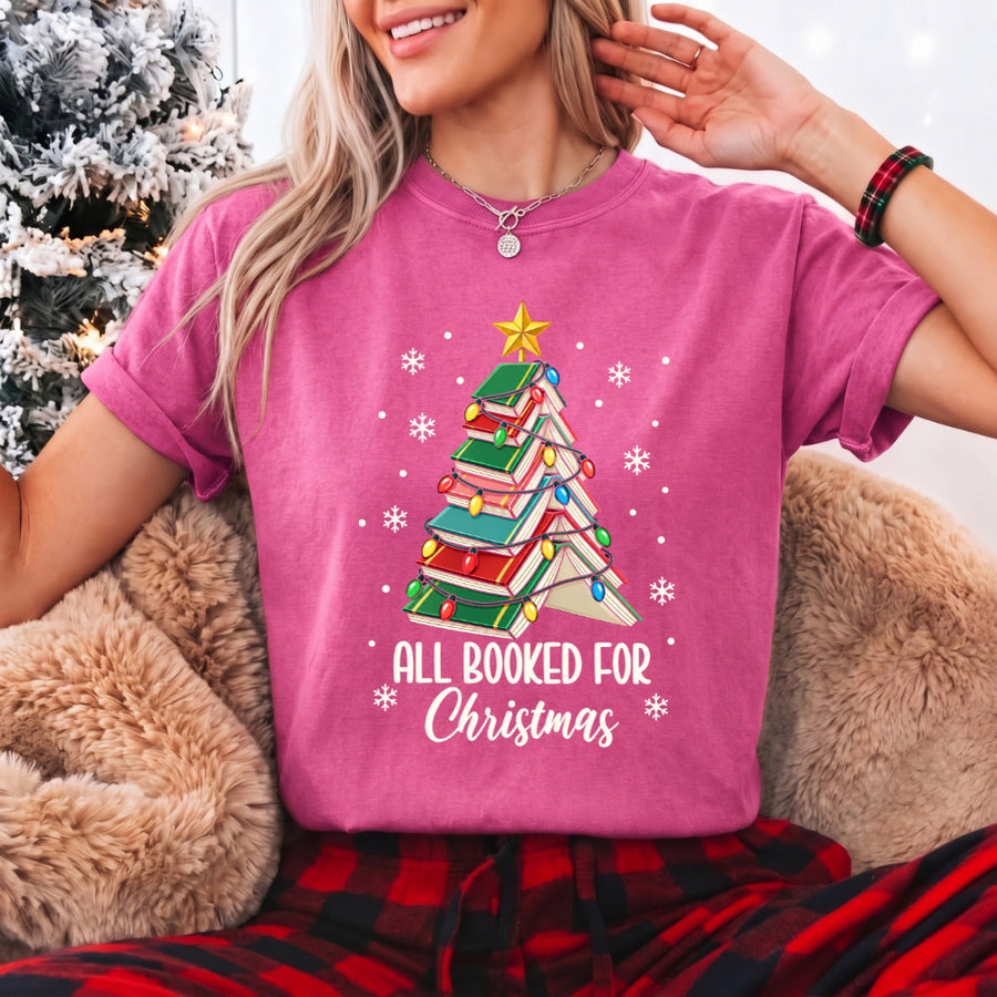 May include an All Booked for Christmas Book Lover Comfort Colors T-Shirt featuring a festive Christmas and reading-inspired design.