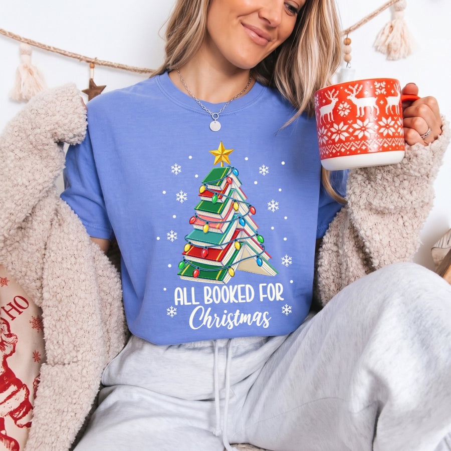 May include an All Booked for Christmas Book Lover Comfort Colors T-Shirt featuring a festive Christmas and reading-inspired design.