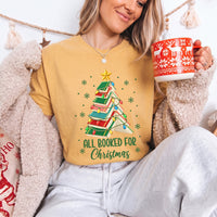 May include an All Booked for Christmas Book Lover Comfort Colors T-Shirt featuring a festive Christmas and reading-inspired design.